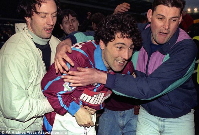 Support act: Villa fans mob Saunders after the penalty shootout win