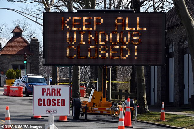 A large sign instructs motorists to keep vehicle windows closed as they cross into the COVID-19 testing facility New Rochelle