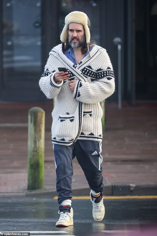 Cancelled? No, Russell Brand’s coining it: He dines at the local Ivy barefoot in a kimono. And he’s turned the village pub into an HQ pumping out online conspiracy theories that earn him millions…